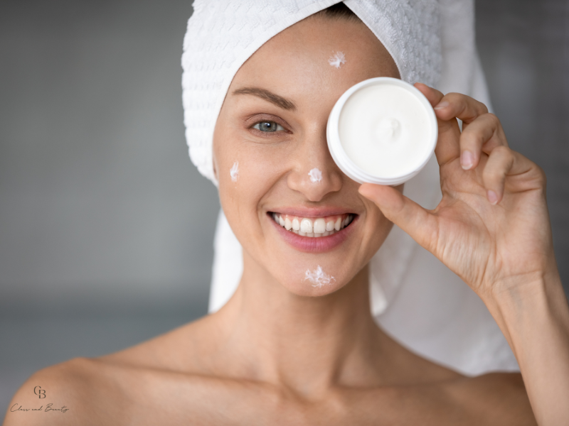 Woman holding a moisturizer as the final step of her skincare routine