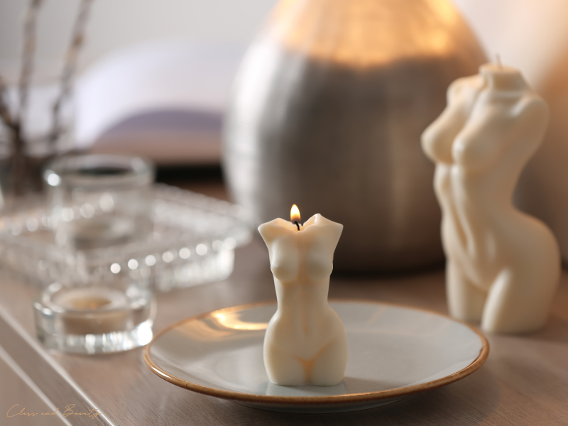 Elegant decor featuring a candle and a statue symbolizing feminine body shape types